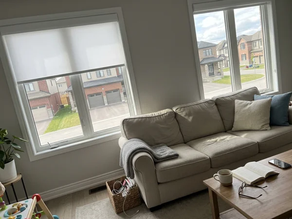 Bright white roller blinds in a staged Longfields living room