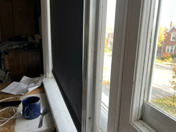 Side channel track holding the edge of a blackout roller fabric