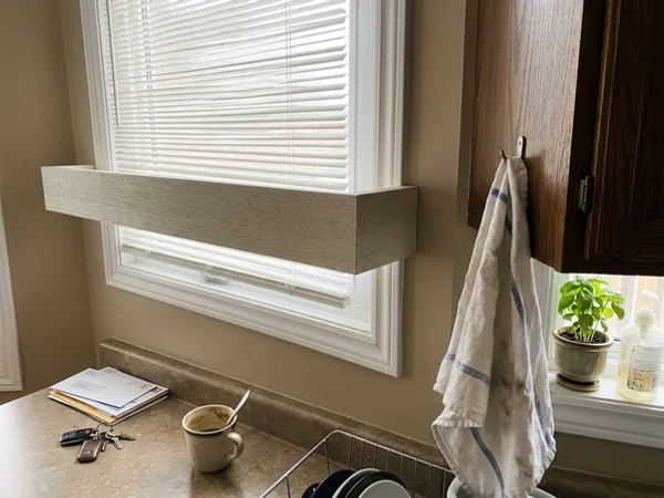 Faux wood blind valance return wrapping the frame in a Nepean kitchen