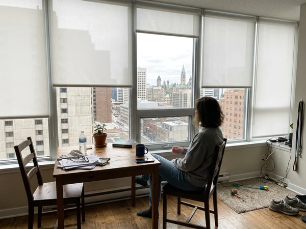 Motorized roller shades in a Centretown condo unit with floor-to-ceiling glass