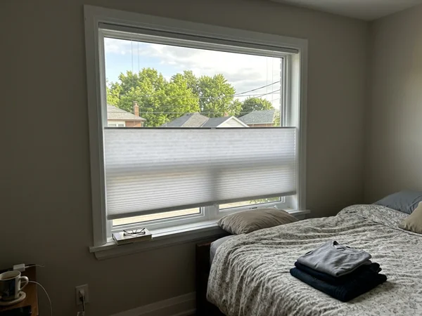 Top-down bottom-up cellular shade lowered from the top in a Glen Cairn bedroom